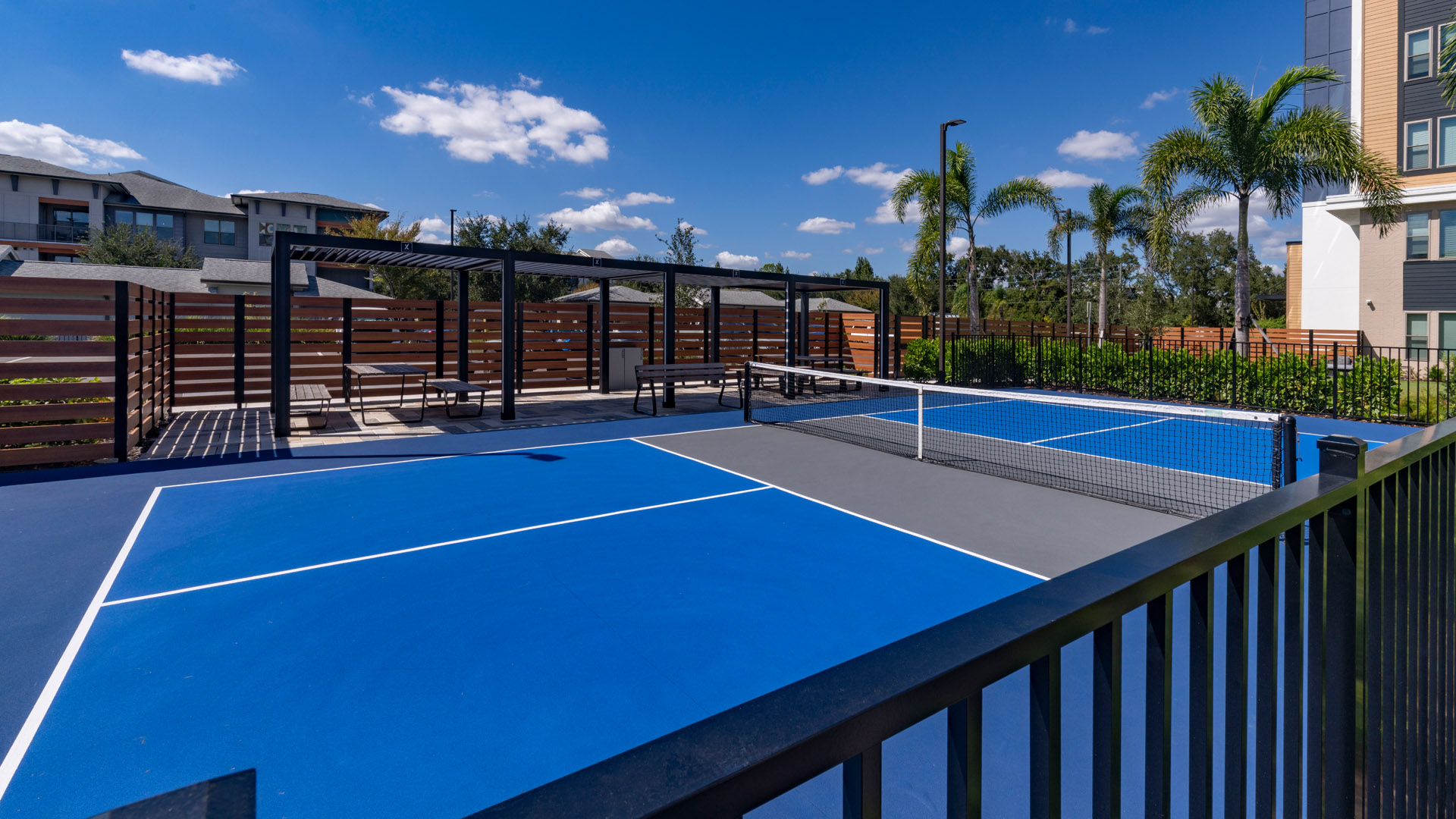 Blue tennis courts under clear sky