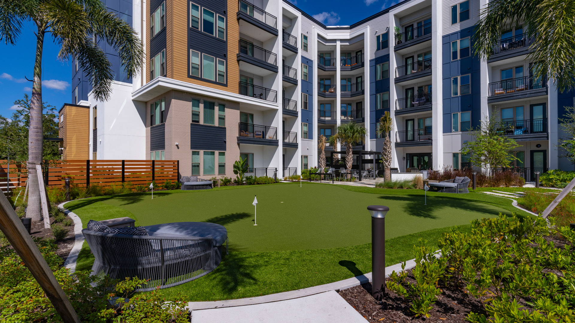 Modern apartment complex with green lawn
