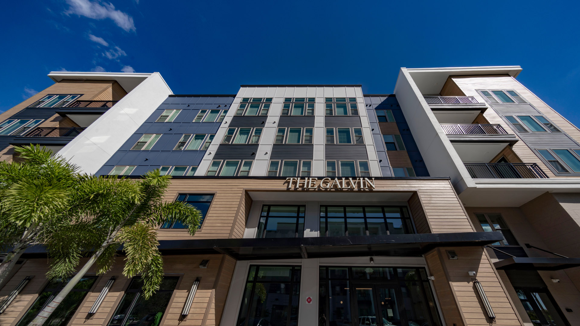 Modern apartment building with palm trees