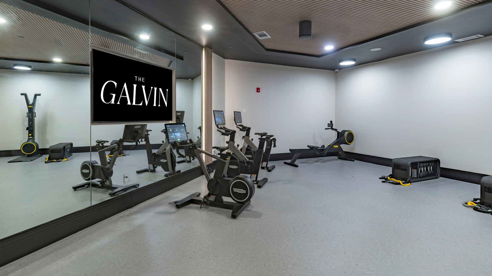 Modern gym with exercise equipment.
